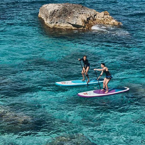 two female friends paddle boarding on their Red Paddle Co 10'6" Rides