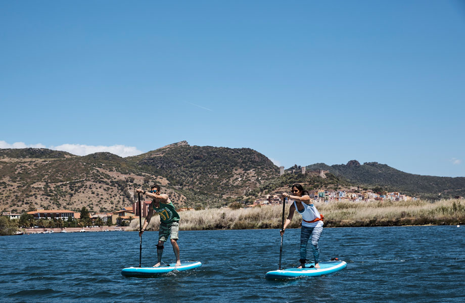 couple paddle boarding in Bosa, Sardinia
