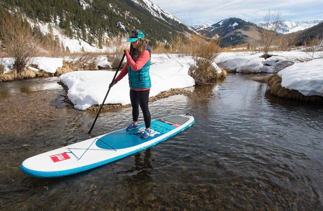 Stand up Paddler on river in snow 