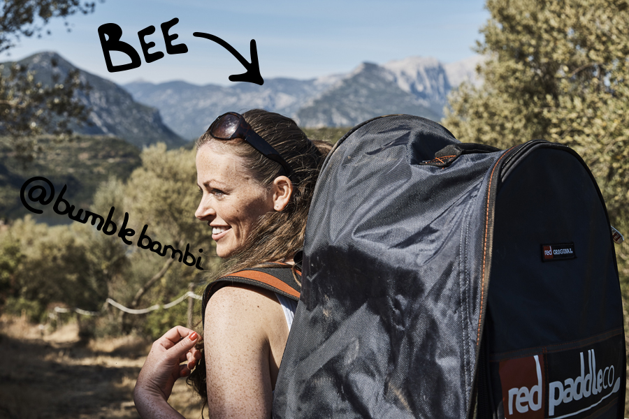 Girl smiles carrying her Red paddle co backpack