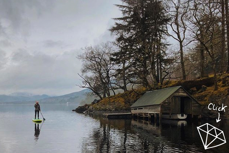 girl paddles on loch in winter 