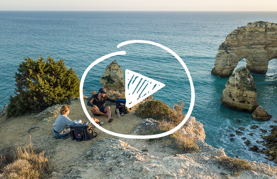 Friends sit and have picnic on cliff