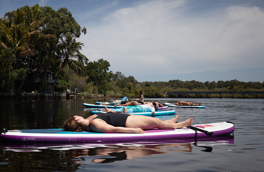 shavanasna pose on a sup on water