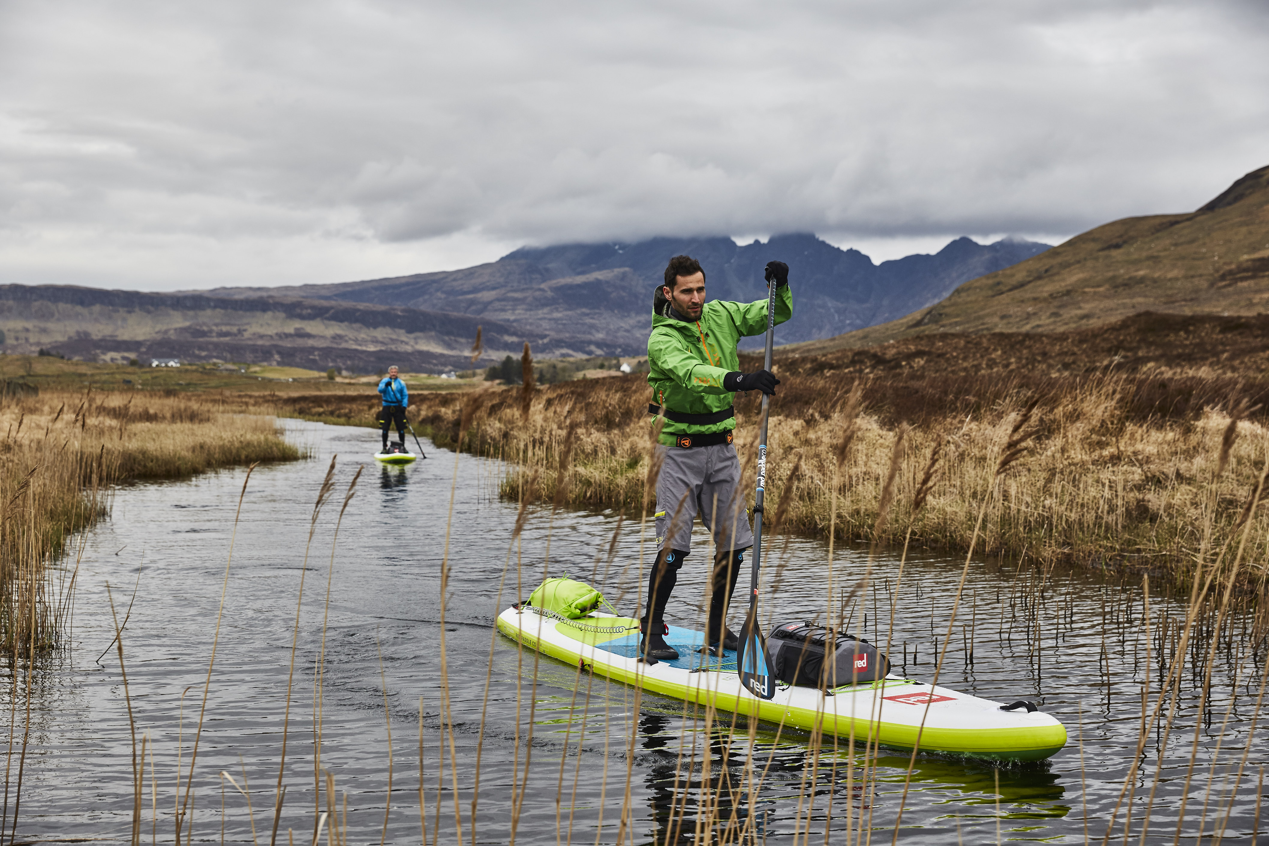 two men paddle boarding in winter at Isle of Skye, Scotland