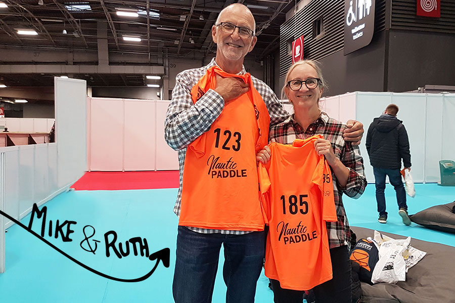 Couple pose at Nautic SUP in Paris with race bibs